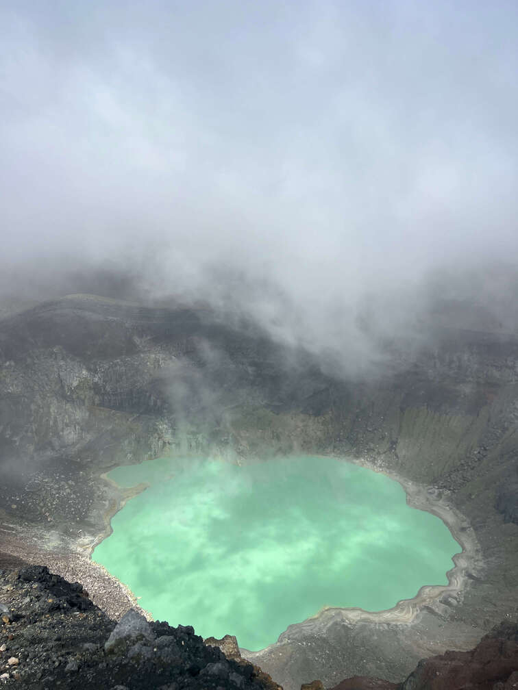 Santa Ana volcano crater, with a green lagoon inside.