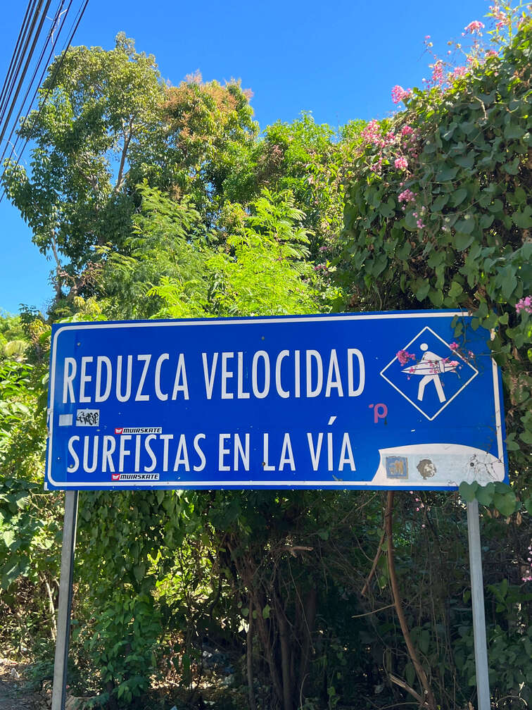 Surfers on the road sign in El Tunco.