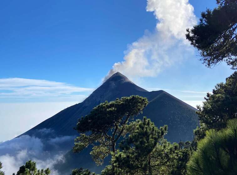 Frontal view of Acatenango Volcano with smoke on the top.