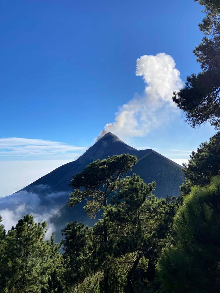 Frontal view of Acatenango Volcano with smoke on the top.