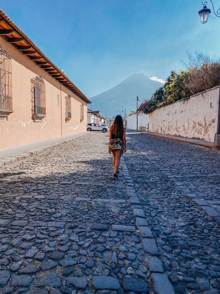 Cobbled street in Antigua with Volcan de Agua in the background.