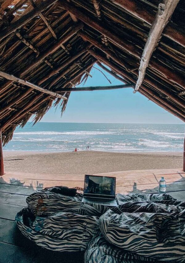 Digital nomad equipment inside a shut in El Paredon, a black-sand beach located in Guatemala.