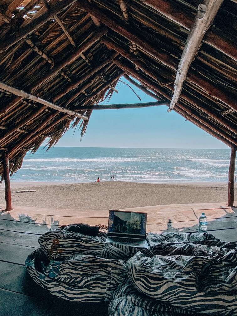 Digital nomad equipment inside a shut in El Paredon, a black-sand beach located in Guatemala.