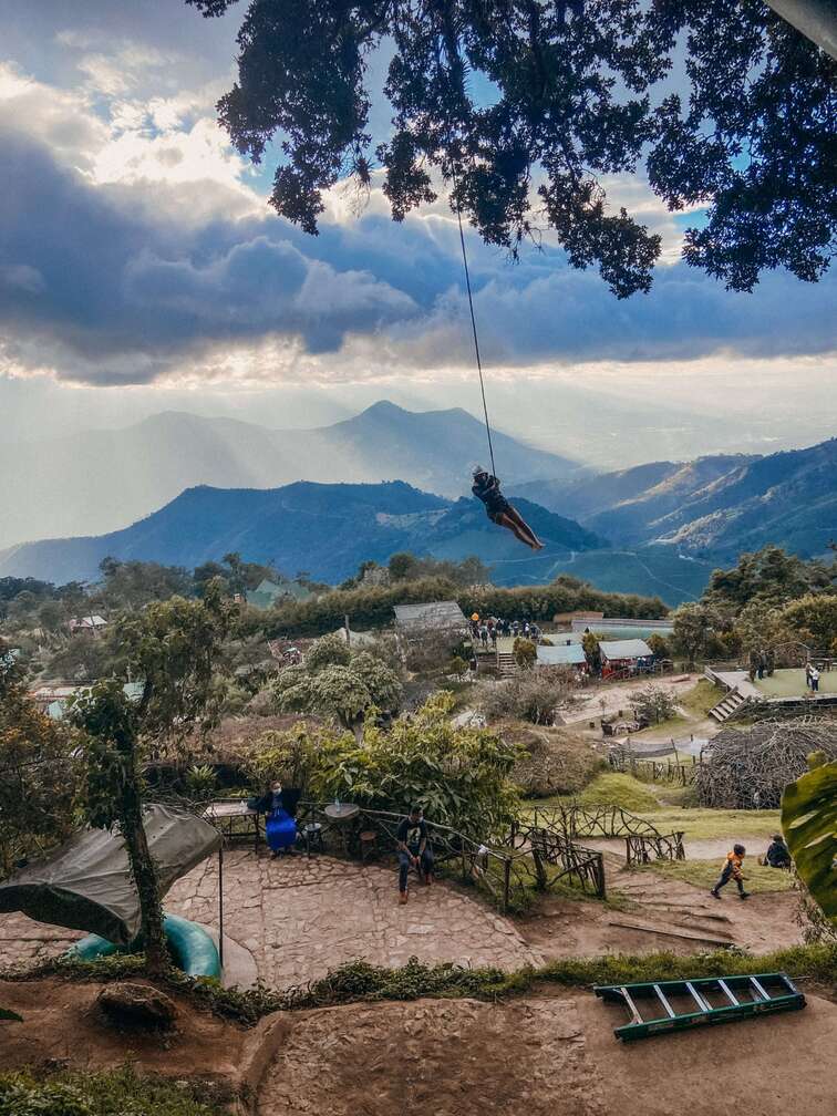 Giant swing with mountains on the background.