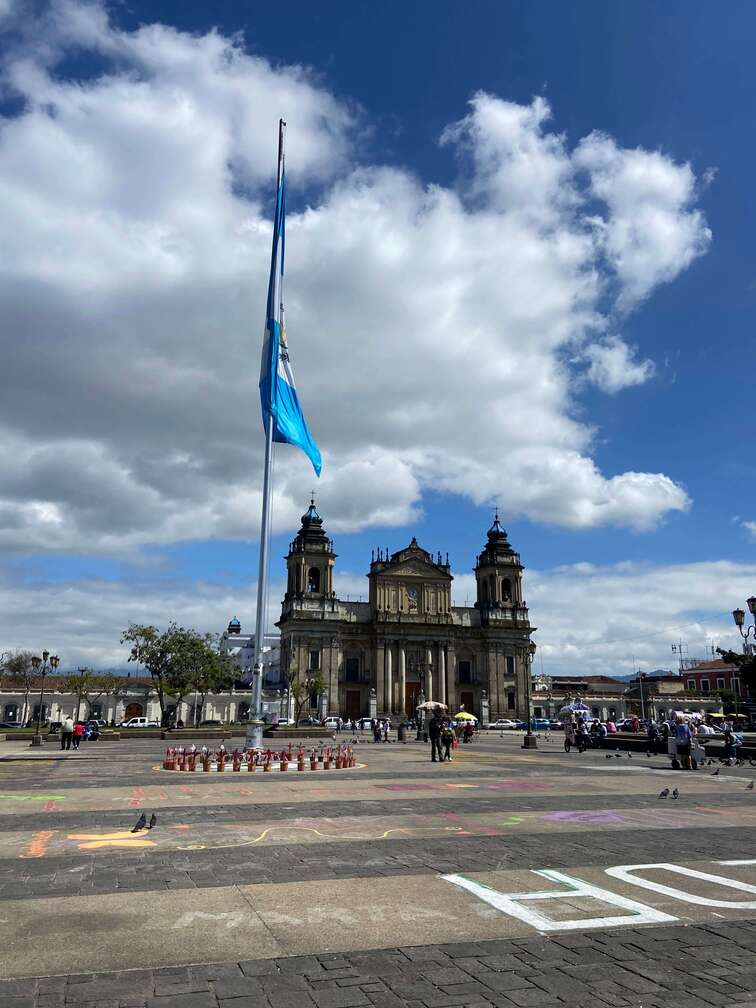 Main plaza in Guatemala city with the national flag in the middle.