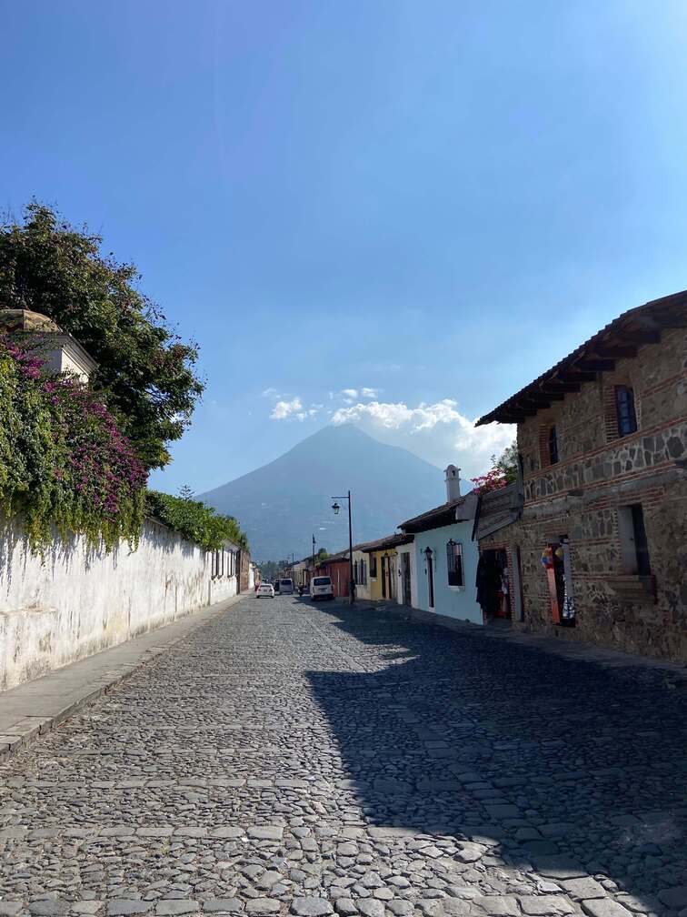 Cobbled street in Antigua with Volcan de Agua in the background.